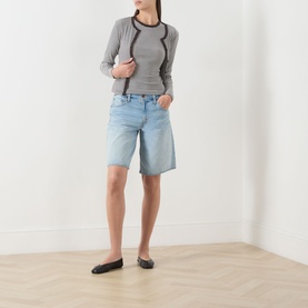 Model wearing Samsoe & Samsoe mulch stripe fitted long-sleeve top with dark trim, styled with light blue denim shorts and black ballet flats.