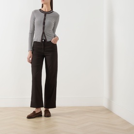 Model wearing Samsoe & Samsoe mulch stripe top with contrast trim, styled with wide-leg black trousers and dark loafers.
