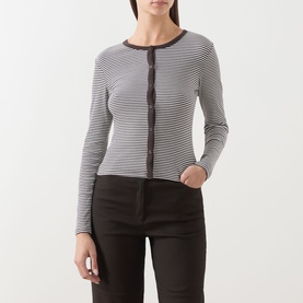 Model wearing Samsoe & Samsoe top in Mulch St. stripe, long-sleeve fitted ribbed style with contrast button-through front, styled with black trousers.