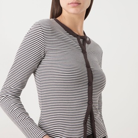 Model wearing Samsoe & Samsoe top in Mulch stripe, fitted ribbed cotton with dark brown and white stripe pattern and button-front detail.