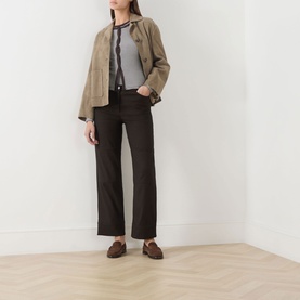 Model wearing Samsoe & Samsoe Mulch St. top styled with a tan suede jacket and dark wide-leg trousers.