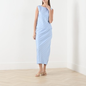 Model wearing Samsoe & Samsoe Saagne Tonal Striped Blouse in Windsurfer, styled with a matching blue midi skirt and nude heels.