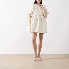 Model wearing Sister Jane Chalk Mini Dress in white with puff sleeves and voluminous skirt, styled with white heeled mules