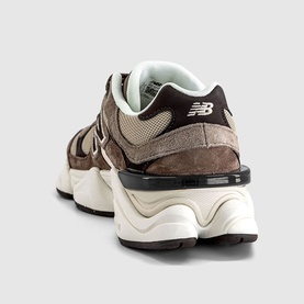 New Balance 9060 trainer in brown and orewood white, featuring suede panelling, chunky layered midsole, and cream interior lining, rear view