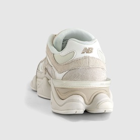 New Balance 9060 trainer in sea salt off-white, suede and mesh upper, chunky cream midsole, silver NB logo, rear three-quarter view