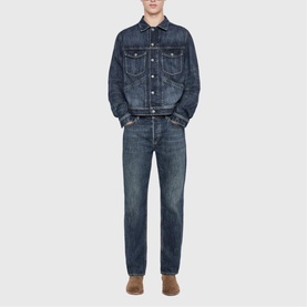 Model wearing All Saints dark indigo denim jacket and matching jeans, styled with tan suede boots.