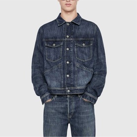 Model wearing All Saints dark indigo denim jacket with chest pockets and silver buttons, styled with matching denim jeans.