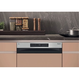 Hotpoint MaxiSpace Integrated Full Size Dishwasher with 3rd Rack, stainless steel control panel, fitted within warm-toned kitchen cabinetry