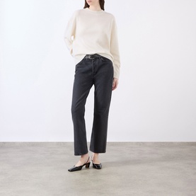 Model wearing Anine Bing Lee Cashmere Sweater in cream with crew neck and dropped shoulders, styled with dark grey straight-leg jeans.
