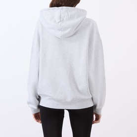 Model wearing Anine Bing Harvey New Classic Hoodie in Grey Melange, rear view showing dropped shoulders and ribbed hem, styled with black trousers