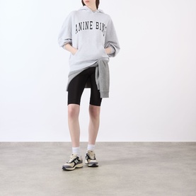 Model wearing Anine Bing Harvey New Classic Hoodie in Grey Melange with black cycling shorts and grey trainers.
