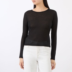 Model wearing Anine Bing black sheer knit long-sleeve top with white jeans