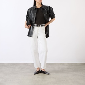 Model wearing Anine Bing black lyocell-wool top, styled with white straight-leg jeans, black leather overshirt and black loafers.