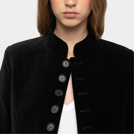 Model wearing Zadig black velvet jacket with mandarin collar and decorative silver-tone buttons, styled over white top.