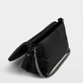Zadig black textured clutch bag with studded edges, silver chain strap, and fold-over flap closure, angled view