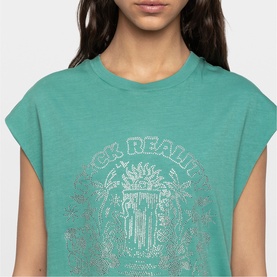 Model wearing Zadig green sleeveless crop T-shirt with silver rhinestone graphic print detail at chest.