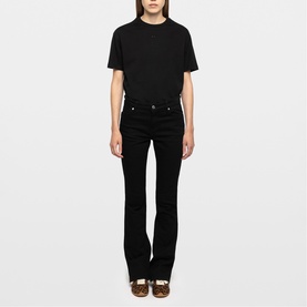Model wearing black T-shirt and black flared jeans with Zadig brown shoes, full-length front view.