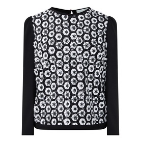 Caroline Kilkenny top in white and black with floral hexagon lace-effect front panel and plain black long sleeves, crew neck, keyhole back