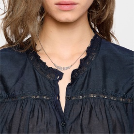 Model with Zadig silver-tone necklace featuring delicate bar detail, styled with a navy blue lace-trim blouse