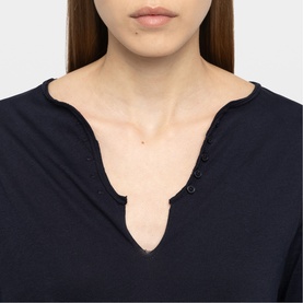 Model wearing Zadig blue top with scalloped V-neckline and button detail, close-up view
