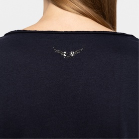 Model wearing Zadig blue top, rear view showing rhinestone eagle wing logo embroidered at upper back neckline.