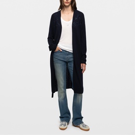 Model wearing Zadig blue longline open-front cardigan with pointelle detail, styled with white vest and light wash wide-leg jeans