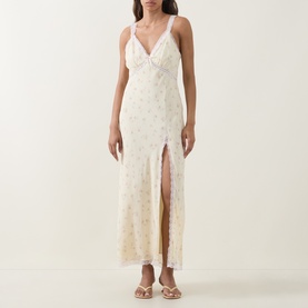 Model wearing LOVESHACKFANCY Lemon Haze floral maxi dress with V-neck, lace trim, front split, styled with strappy sandals.