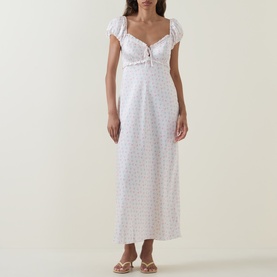 Model wearing LOVESHACKFANCY Ivory Rose floral midi dress with puff sleeves, sweetheart neckline and ruched bust detail, styled with silver sandals