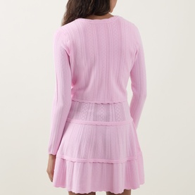 Model wearing LOVESHACKFANCY Candy Floss Pink knit top, back view, styled with matching tiered mini skirt