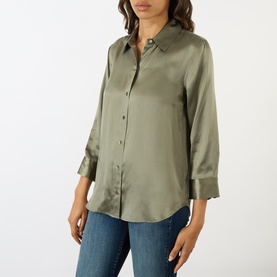 Model wearing LAgence Smokey Olive silk blouse with 3/4 sleeves, point collar and button front, styled with blue jeans.