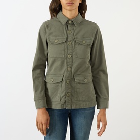Model wearing LAgence Smokey Olive jacket with four flap pockets and button front, styled with blue jeans.