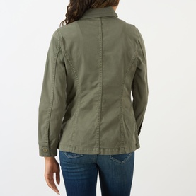 Model wearing LAgence Smokey Olive cotton-linen jacket, back view, styled with blue denim jeans