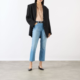 Model wearing LAgence light blue slim jeans with black blazer, blush shirt, and black flats