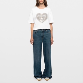 Model wearing Zadig blue wide-leg jeans with white graphic heart-print T-shirt
