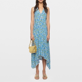 Model wearing Zadig yellow floral midi dress with asymmetric hem and V-neckline, styled with gold mini bag and strappy sandals