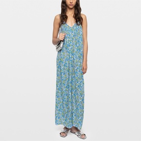 Model wearing Zadig yellow floral maxi dress with spaghetti straps and V-neckline, styled with a small white bag.