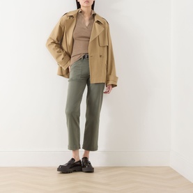 Model wearing Paige Quincy Ankle Straight-Leg Jeans in Vintage Ivy Green, styled with a camel crop jacket, ribbed top and black loafers.