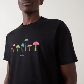 Model wearing Paul Smith Mushrooms Logo T-Shirt in black, featuring colourful mushroom graphic print on chest, crew neck, short sleeves