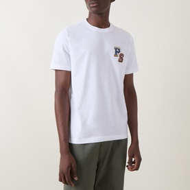 Model wearing Paul Smith white crew neck cotton T-shirt with embroidered PS logo chest detail, styled with khaki trousers.