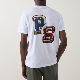 Model wearing Paul Smith white crew neck T-shirt, back view showing large PS varsity letter graphic with stars and 1970 detail.