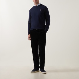Model wearing Paul Smith Very Dark Navy cotton crew neck jumper, styled with a white shirt, black trousers and grey slip-on shoes.