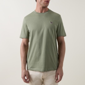 Model wearing Paul Smith Crew Neck T-shirt in light grey green, with small zebra logo embroidery on chest, paired with cream trousers