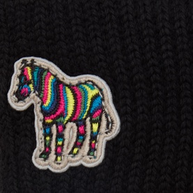Paul Smith Access black wool gloves close-up, featuring multicolour zebra embroidered patch detail on ribbed knit fabric.