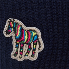 Paul Smith Access blue wool gloves, close-up of multicolour embroidered zebra patch detail on navy knit fabric