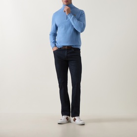 Model wearing Paul Smith Light Blue Cotton Half Zip jumper, styled with dark navy jeans and white trainers.