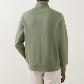 Model wearing Paul Smith Half Zip sweatshirt in light grey-green, rear view, styled with cream trousers