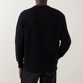Model wearing Paul Smith black cotton sweatshirt, rear view, styled with dark jeans