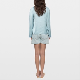 Model wearing Zadig blue long-sleeve top, styled with light grey shorts and tan sandals, rear view