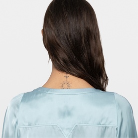 Model wearing Zadig blue satin top, rear view showing neckline detail and small neck tattoo visible