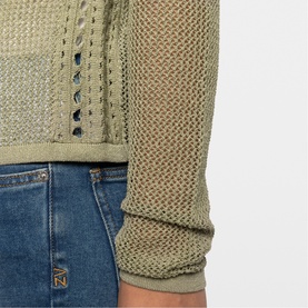 Model wearing Zadig green open-knit textured sweater with mixed stitch pattern, styled with blue denim jeans